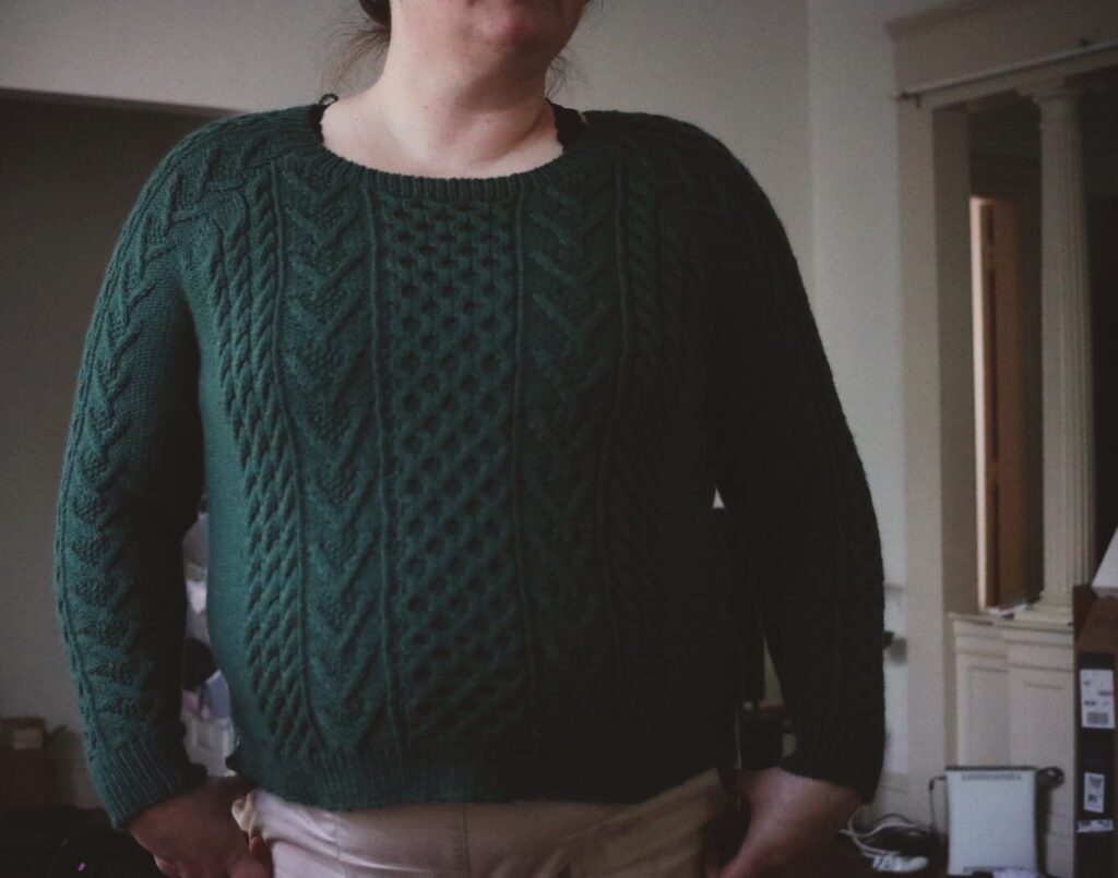 Photo of a sweater that uses a tubular cast on in place of the recommended provisional cast on.
