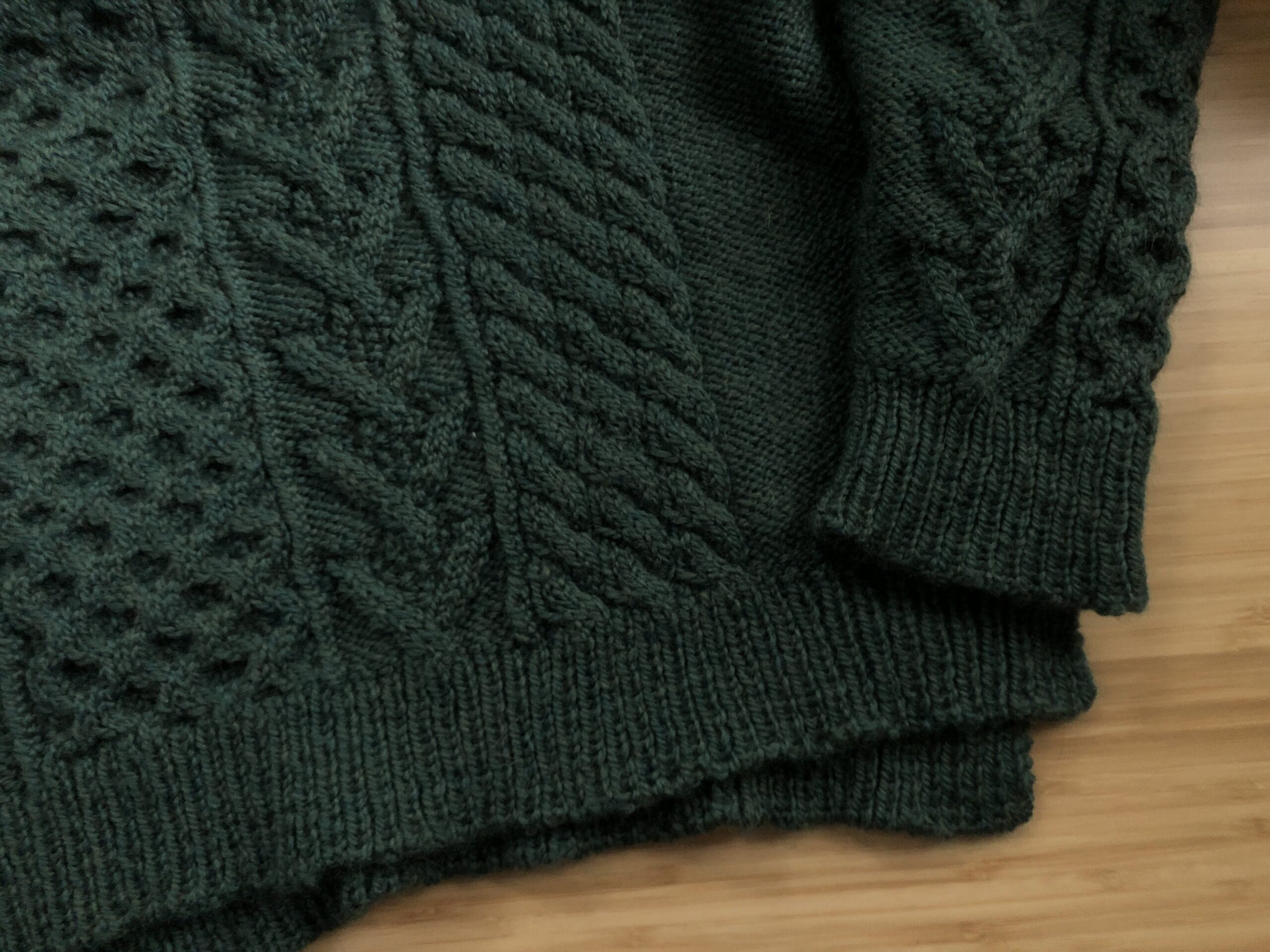 Flat lay photo of the Bronwyn Sweater, focused on the ribbed hems.