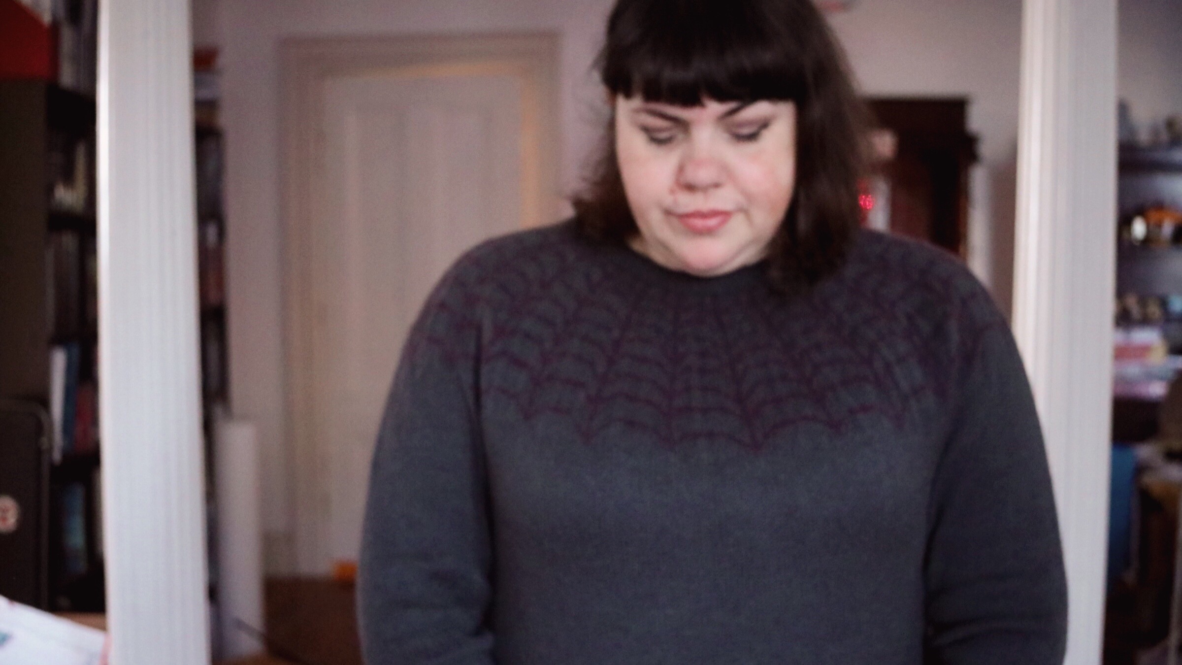 Photo of Amy modeling her Arachne Sweater, designed by Andi Satterlund.